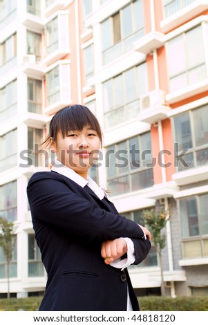 young chinese businesswoman, background is modern business building