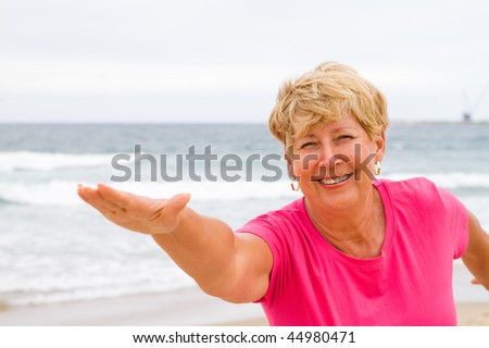 happy and healthy senior woman exercise on beach