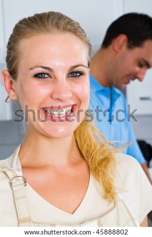 happy woman and boyfriend in kitchen