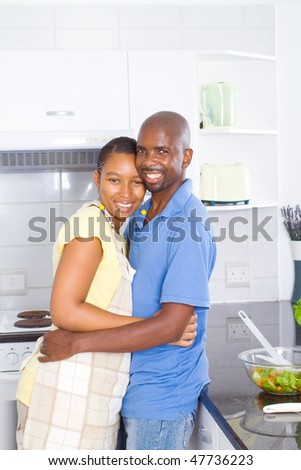 lovely african american couple embracing in kitchen