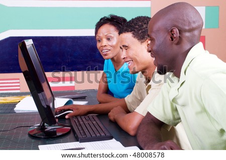 group of adult african american students learning computer
