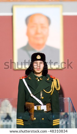 BEIJING, CHINA - DECEMBER 17: A paramilitary police officer guards Tian\'anmen square on December 17, 2009 in Beijing, China.