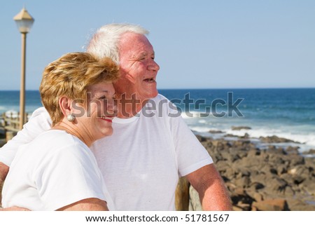 loving senior citizen couple on beach