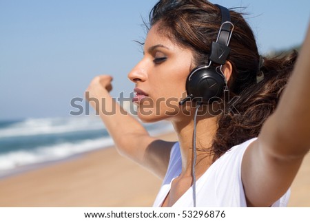 young beautiful woman enjoying music outdoors