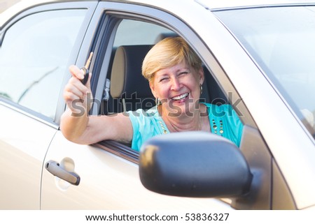 happy senior woman driver inside a car