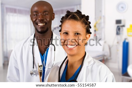 happy african doctor and nurse in hospital ward