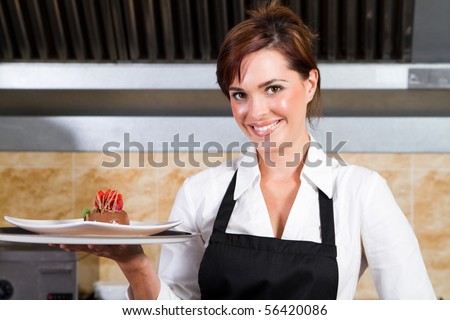 happy waitress holding plate of dessert