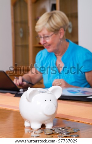 happy senior woman working on her financial papers or paying bills