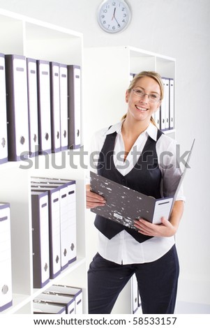 young happy businesswoman searching file in office
