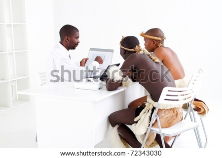 modern african businessman consulting with two traditional tribal clients