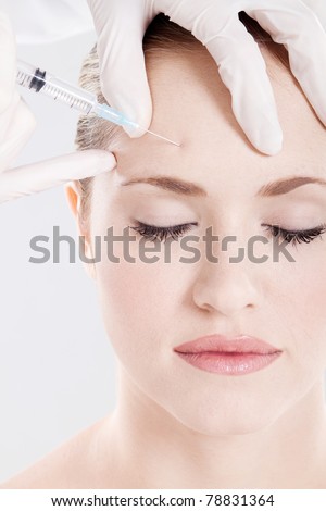 doctor giving on woman\'s forehead