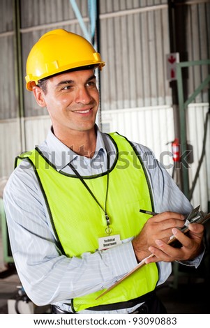 male caucasian technician taking machine gauge reading
