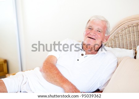 happy senior man lying on bed