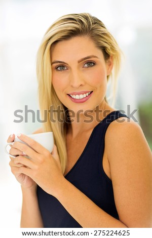 beautiful young woman drinking coffee at home