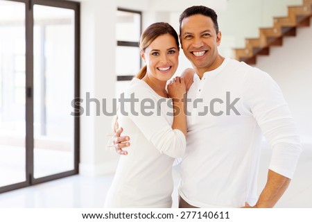beautiful mid age couple portrait in their new house