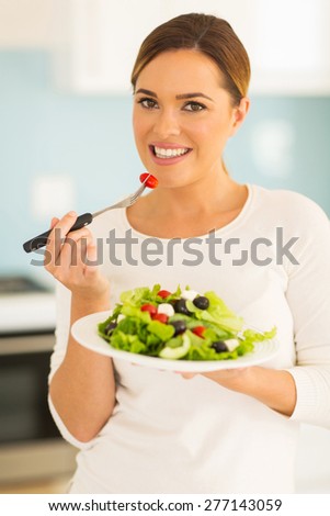 portrait of pretty woman eating salad