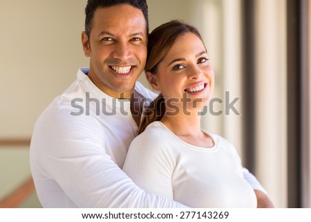 handsome mid age man hugging his girlfriend