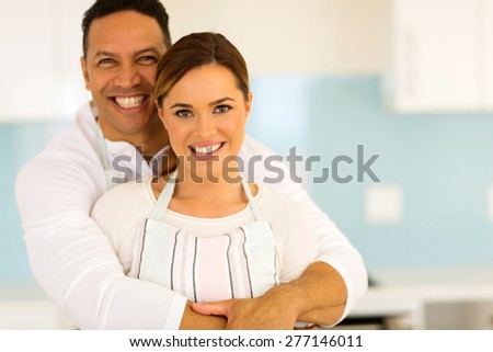 loving couple hugging in kitchen at home