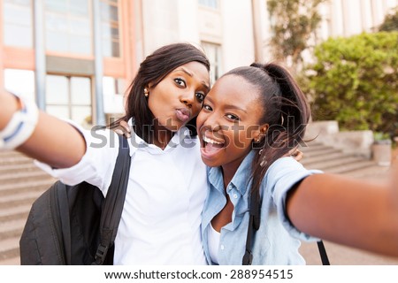 happy african college friends taking selfie together