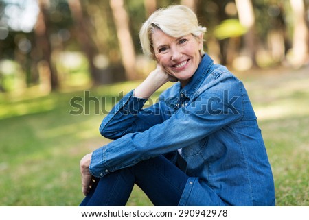 elegant senior woman sitting outdoors