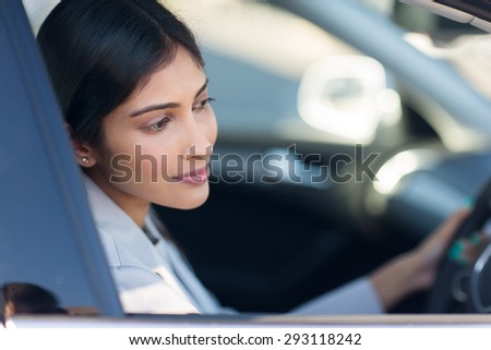 pretty indian woman driving her new car