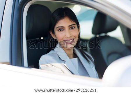 pretty indian woman inside a car