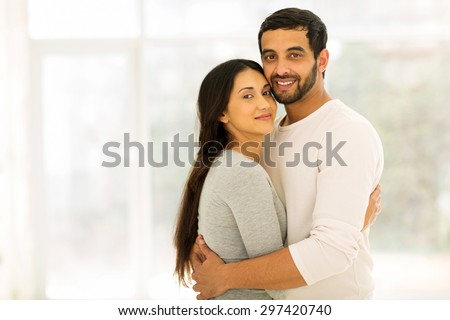 portrait of beautiful couple hugging at home