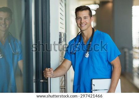 portrait of handsome doctor opening his office door