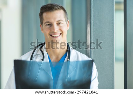 portrait of happy young medical doctor with x ray