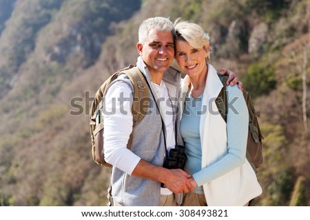 portrait of happy couple hiking in autumn mountain