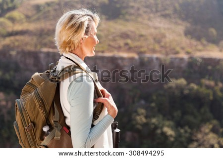 happy senior female hiker enjoying outdoor activity