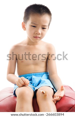 Boy own treat on his knee wound from accident
