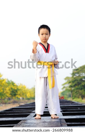 Asian boy practice Taekwondo at the construction area