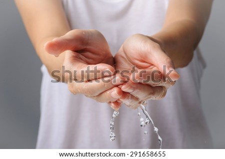 Thin focus Close up on woman hand and water drop and blur body in white shirt