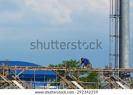 Worker without helmet construct a white building under the day light