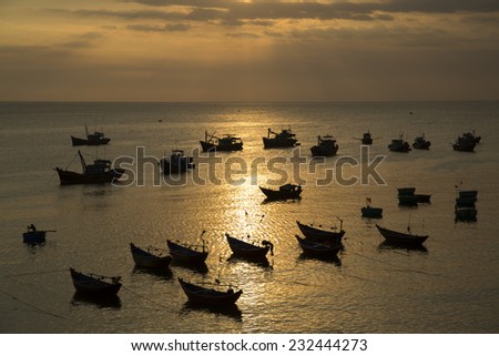Group of anchored small fishing boats during sunset in Vietnam