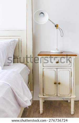 bedroom interior design with White pillows on white bed and decorative table lamp