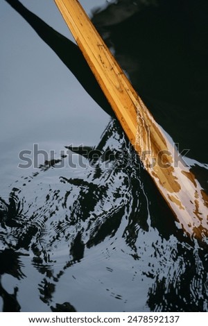 Similar – Image, Stock Photo The gondolas splash in the blue calm water. They are attached to wooden poles.