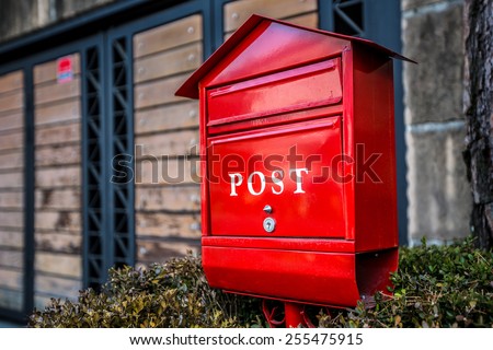 red post box or mailbox postbox letterbox on the street