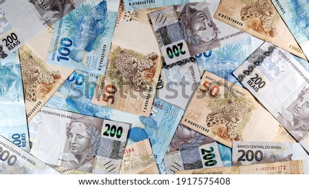 various money notes of 50 reais 100 reais and 200 reais from brazil on a wood background. space for text. money from brazil. earn money. Real, Currency, Money, Dinheiro, Reais, Brasil.
