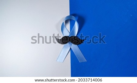 November Prostate Cancer Awareness month. Blue Ribbon with mustache for supporting people living and illness. Healthcare, International men, Father and World cancer day concept.