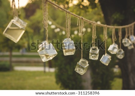 Autumn street art - glass jars ornaments in a park, with trees and alleys in the background.