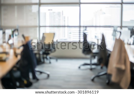 Abstract office blur background with wooden desk, chair with laptop/pc and display