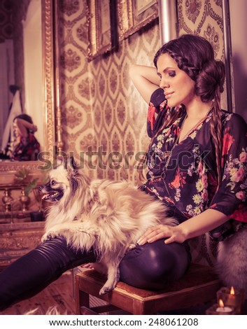 Beautiful Hipster Woman in classic interior with pomeranian(Dog). VIntage/Retro
