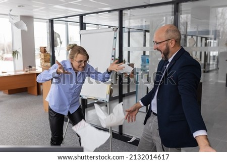 Angry office workers tear up contracts in modern office space after receiving bad news.Business office workers throwing crumpled paper, nervous breakdown at work, screaming in anger, relieve stress. Сток-фото © 