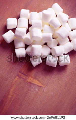 Heap of Small White Marshmallows on the Brown Wooden Background, Selective Focus, Toned Image