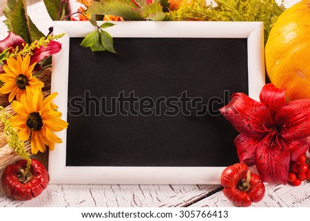 Autumn frame with flowers, vegetables and leaves. Harvesting, thanksgiving day or fall concept over white wooden background. Space for text. Selective focus