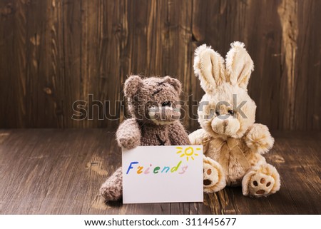 Friends forever. Greeting card. Friendship concept: cute fur toys on wooden background. Vintage style, selective focus