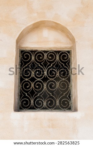 A Dark Window With Metallic Bars in Front