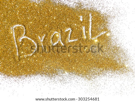 Blurry inscription Brazil on golden glitter sparkles on white background